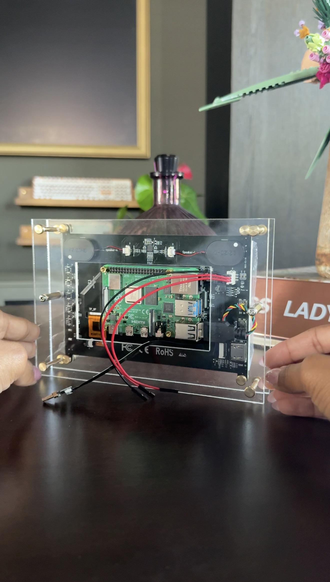 The custom acrylic case for the display.